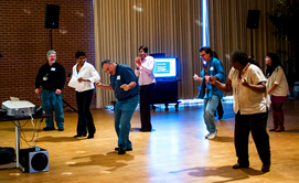 OIT employees dancing at the 2012 Holiday party in the Student Union.