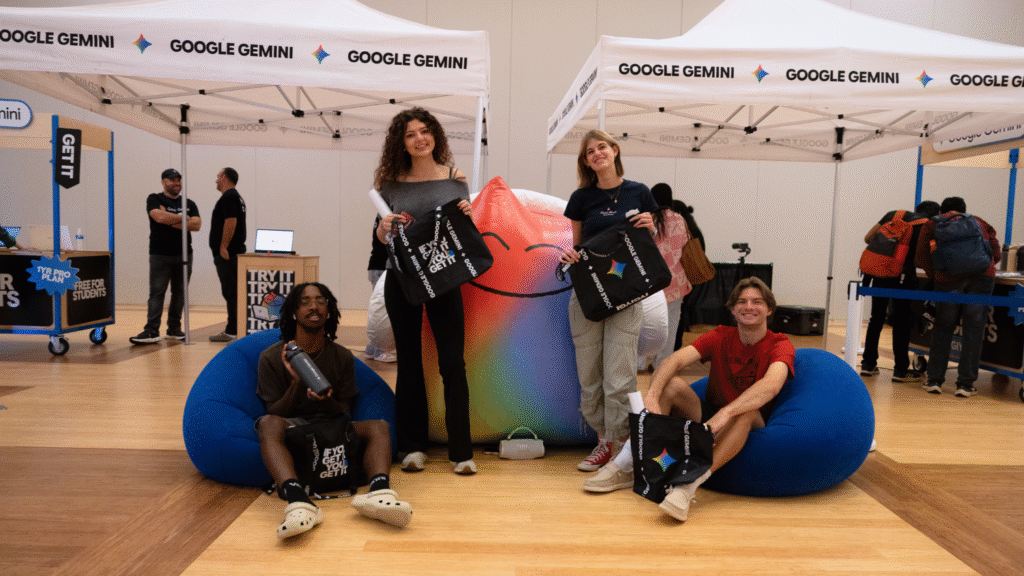 Students pose with an inflatable Gemini mascot and their swag items.